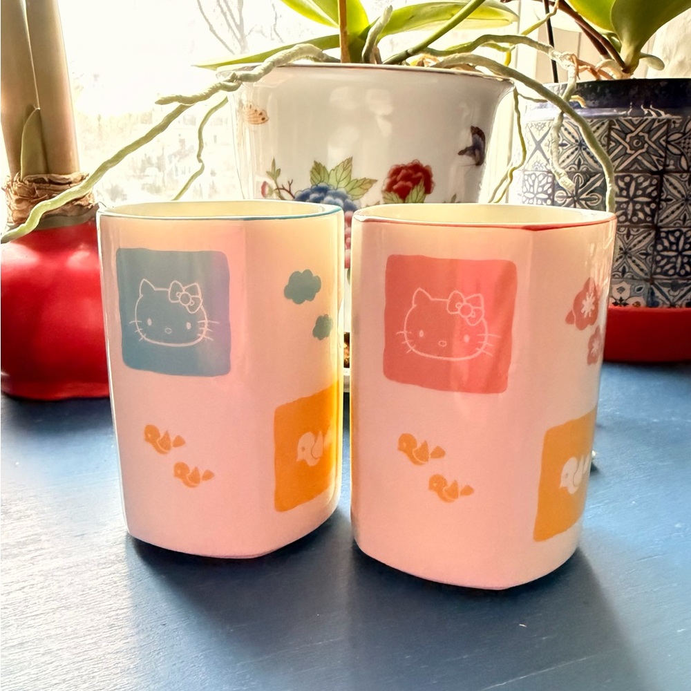 Set of two ceramic teacups featuring Hello Kitty illustrations.